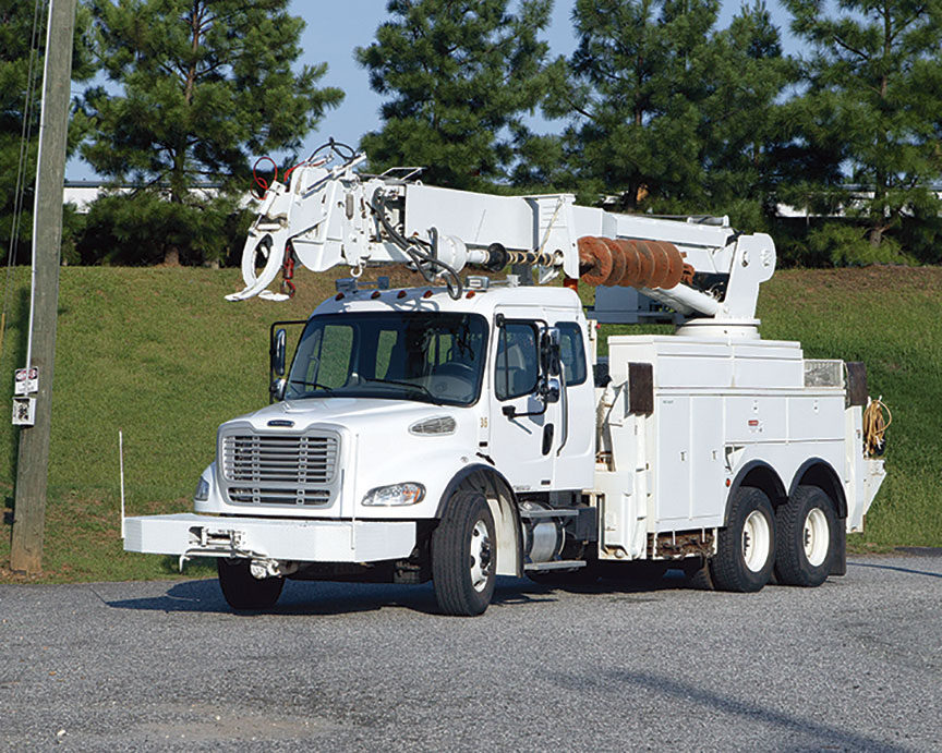 White utility truck with an aerial boom.